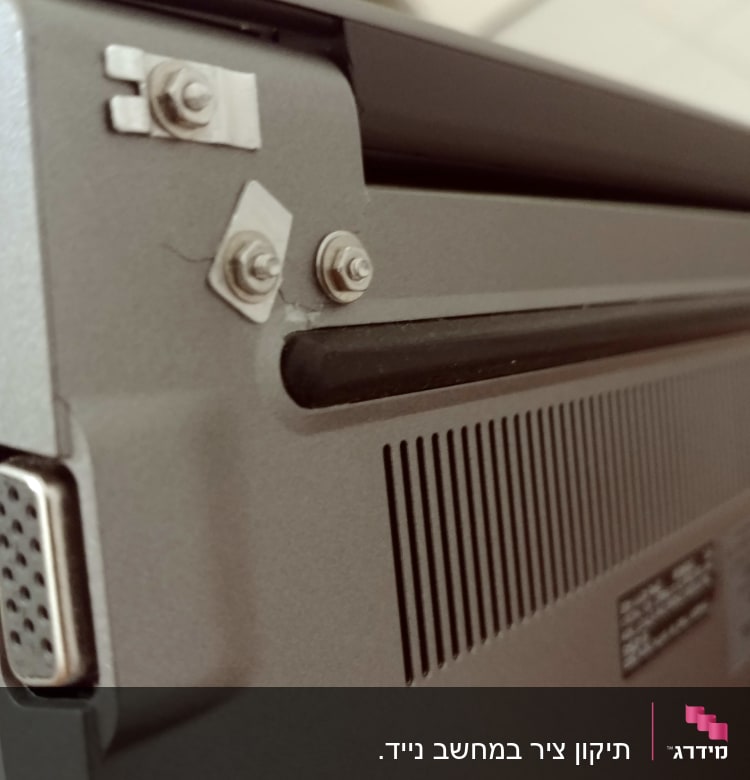 חלק אחורי של מחשב נייד עם ברגים ופתחי אוורור